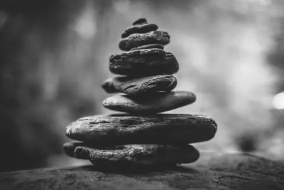 A stack of flat rocks balancing a top of each other.